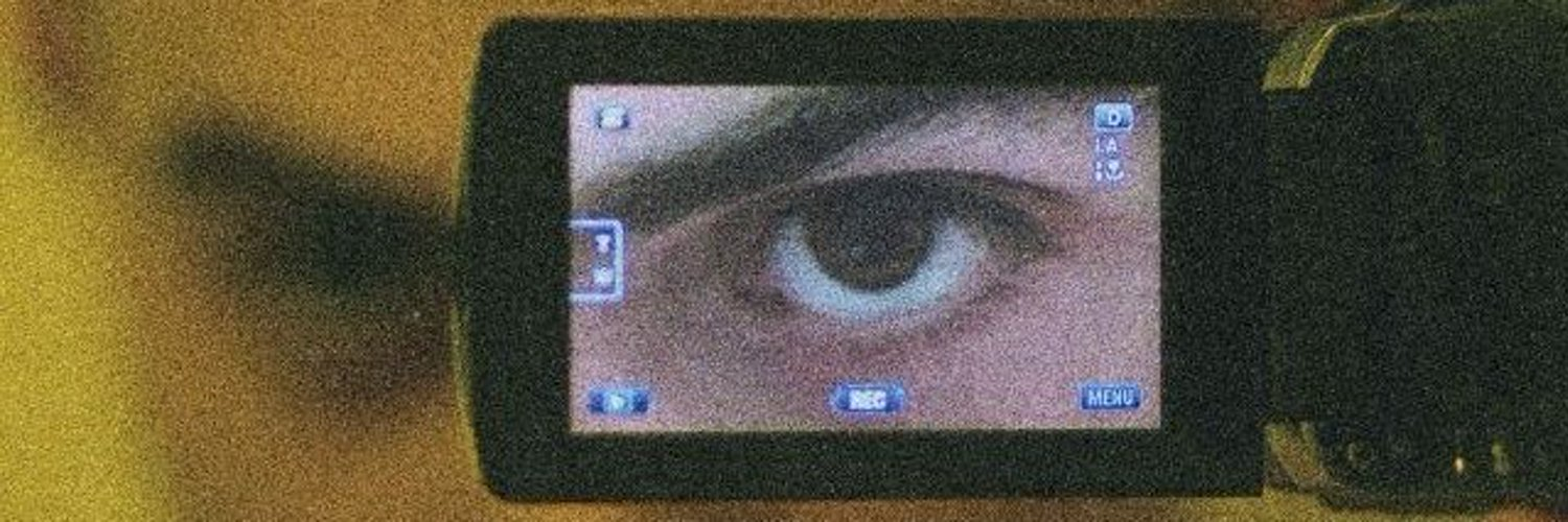 A retro computer with a blue eye on its screen
